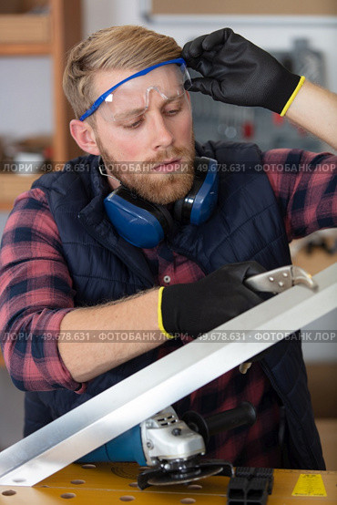 carpenter working carefully looking at the plans. Стоковое фото, агентство Ingram Publishing / Фотобанк Лори