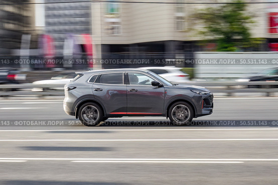 Changan CS55 Plus car moving in the street. Man is driving fast SUV car in gray color on a city highway. Редакционное фото, фотограф Константин Григорьев / Фотобанк Лори
