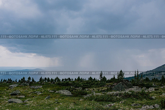 Change of weather in the mountains, thundercloud brought heavy rain like a wall. Natural landscape on hike at summer day. Стоковое фото, фотограф Екатерина Якименко / Фотобанк Лори