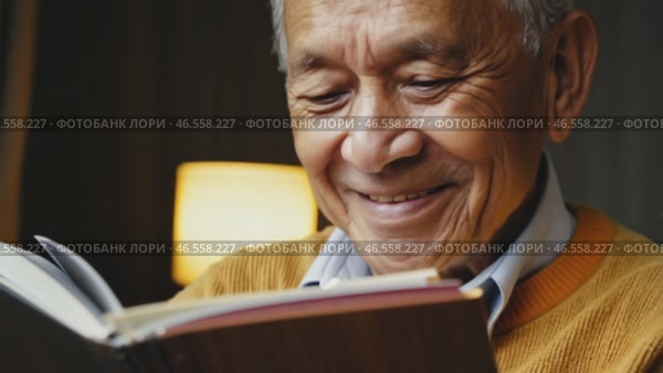 Cheerful elderly man with gray hair, in a yellow sweater and a shining smile looks at the camera, 4k. Advertisement of a nursing home, an active lifestyle in retirement, Handsome grandfather is thinking about something. Стоковое видео, видеограф ALLA YURTAYEVA / Фотобанк Лори