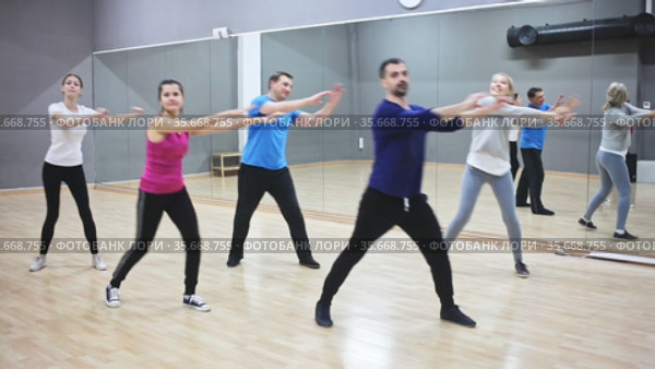 Cheerful young woman enjoying active dances in modern dance studio. Стоковое видео, видеограф Яков Филимонов / Фотобанк Лори