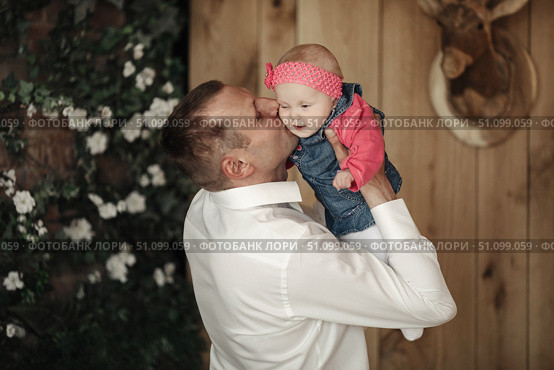 Cherishing Those First Years, Father Gently Kisses Baby Daughter. Стоковое фото, фотограф Aleksandr Golubev / Фотобанк Лори