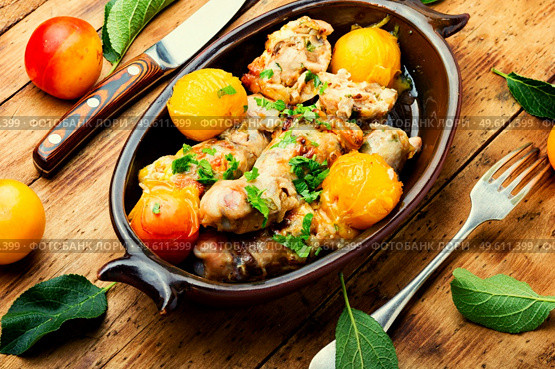 Chicken leg stuffed with mushroom and cherry plum. Baked meat dish with fruit. Chicken drumstick stuffed with plum. Стоковое фото, агентство Ingram Publishing / Фотобанк Лори