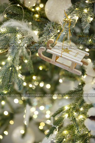 Christmas toy sled hanging on a branch of spruce. Стоковое фото, фотограф Aleksandra Selivanova / Фотобанк Лори