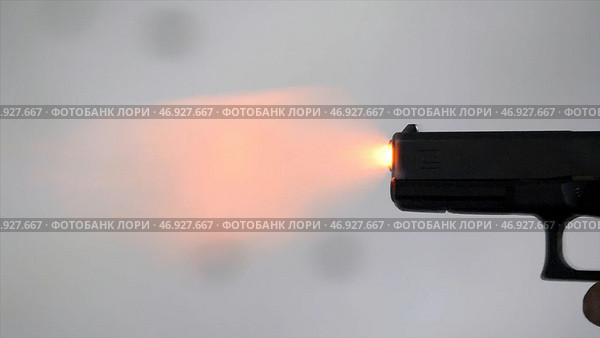 Close profile of man holding a 9 mm handgun, then takes a shot. Стоковое фото, фотограф David Kashakhi / Фотобанк Лори