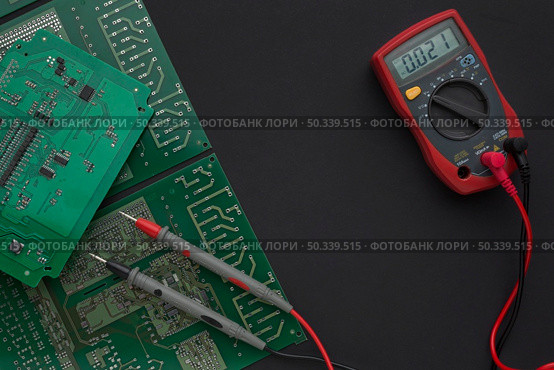 close up circuit board with multimeter. Стоковое фото, агентство Ingram Publishing / Фотобанк Лори