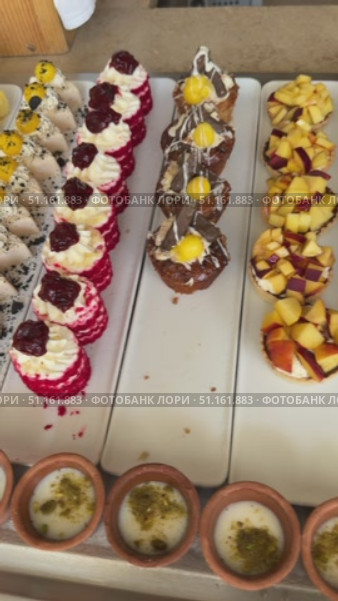 Close up delicious dessert pastry cakes. Fresh colourful sweet berry desserts, beautifully decorated in Egypt Large platters of middle eastern sweets dessert, baklava, pastry, honey, nuts, celebration feast in Egypt  Sweet table with Baklava, layered pastry dessert made of filo pastry sheets, Стоковое видео, видеограф Zita Khasanova / Фотобанк Лори