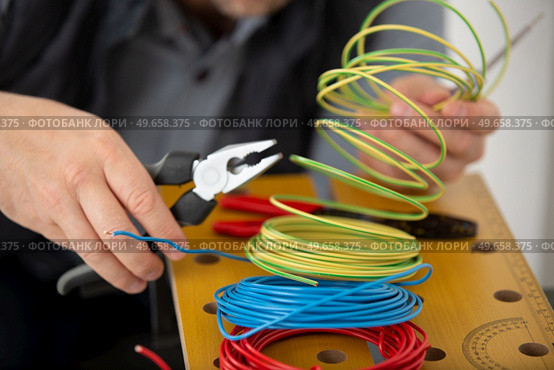 close up electrician wiring at site. Стоковое фото, агентство Ingram Publishing / Фотобанк Лори