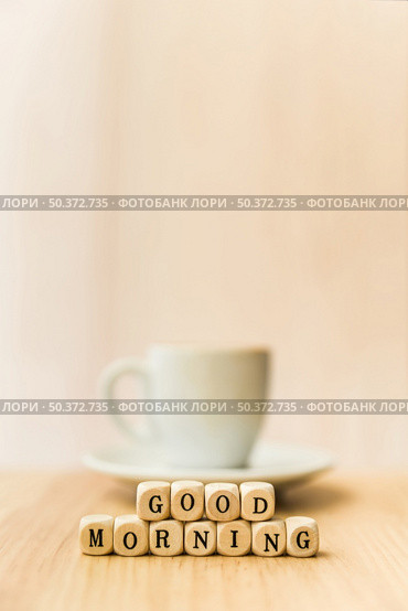close up good morning cubic blocks with cup coffee wooden surface . Стоковое фото, агентство Ingram Publishing / Фотобанк Лори