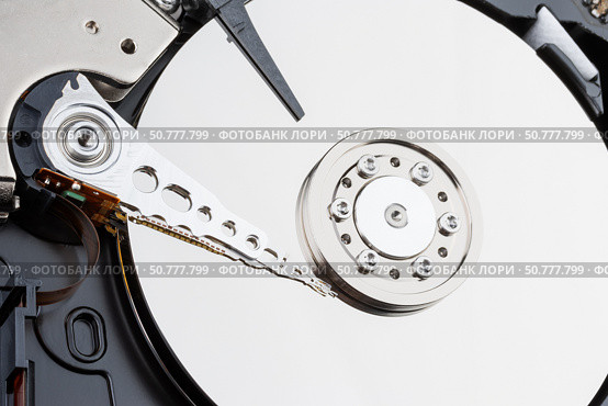 Close-up of the mechanism of a disassembled computer hard disk. Стоковое фото, фотограф Андрей С / Фотобанк Лори