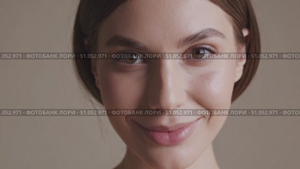 Close-Up Portrait of a Smiling Woman with Natural Beauty and Soft Features, Captured in Two Frames to Highlight Expressive Emotion and Subtle Charm. Стоковое AI-видео, аниматор Владимир Федоров / Фотобанк Лори