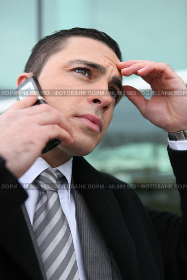 close-up shot of young businessman on the phone looking preoccupied. Стоковое фото, агентство Ingram Publishing / Фотобанк Лори
