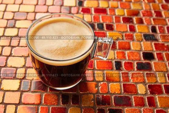 Coffee glass cup with cream on tiles red brown golden table. Стоковое фото, агентство Ingram Publishing / Фотобанк Лори