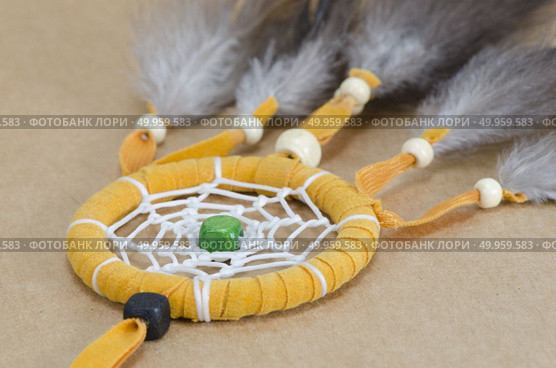colorful dreamcatcher on brown vintage background. Стоковое фото, агентство Ingram Publishing / Фотобанк Лори