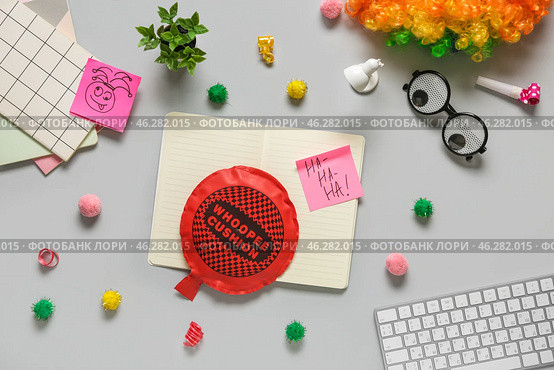Computer keyboard with whoopee cushion, funny glasses and sticky notes on white background. April Fools Day prank. Стоковое фото, фотограф Pixel_shot / Фотобанк Лори