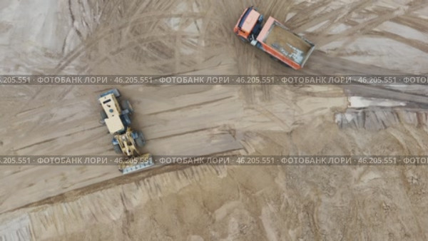 Construction site with a large truck and a smaller truck. Стоковое видео, видеограф Скрипачев Антон / Фотобанк Лори