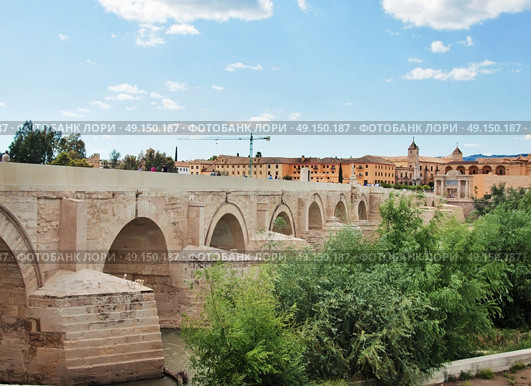 Cordoba, Spain. The Great Mosque (currently Catholic cathedral). UNESCO World Heritage Site. View with famous Roman Bridge and Guadalquivir river. Стоковое фото, агентство Ingram Publishing / Фотобанк Лори