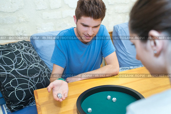 couple in love playing ludo board game. Стоковое фото, агентство Ingram Publishing / Фотобанк Лори