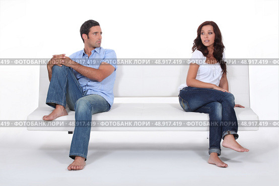 couple sitting apart in couch after quarrel. Стоковое фото, агентство Ingram Publishing / Фотобанк Лори