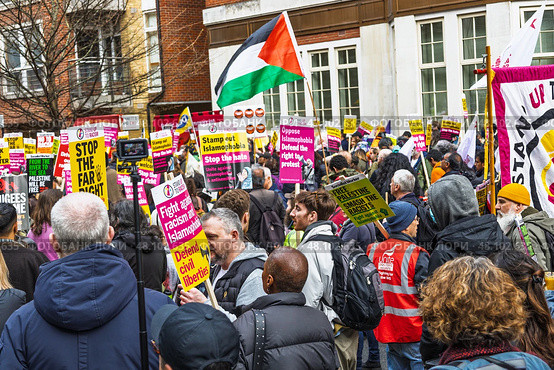 Crowded public demonstration with protesters holding signs and flags. London, UK, 16 March 2024. Редакционное фото, фотограф Zydrius Tartenis / Фотобанк Лори
