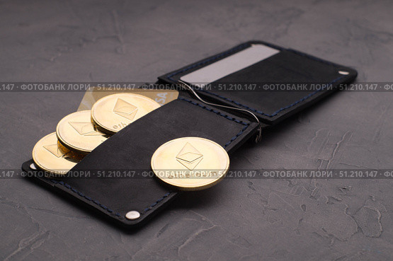 Crypto-currency: a leather purse with plastic cards and ethereum coins. Стоковое фото, фотограф Енваев Андрей / Фотобанк Лори