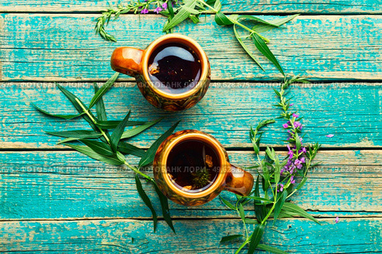 Cup of herbal tea on the table. Ivan tea or fireweed.Willow-herb. Aromatic fireweed tea. Стоковое фото, агентство Ingram Publishing / Фотобанк Лори
