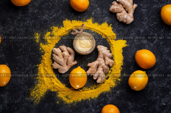 Curcuma (turmeric) spice , ginger, lemon and honey  served at black table. Cuisine ingredients. healthy concept.  flat lay. Стоковое фото, агентство Ingram Publishing / Фотобанк Лори