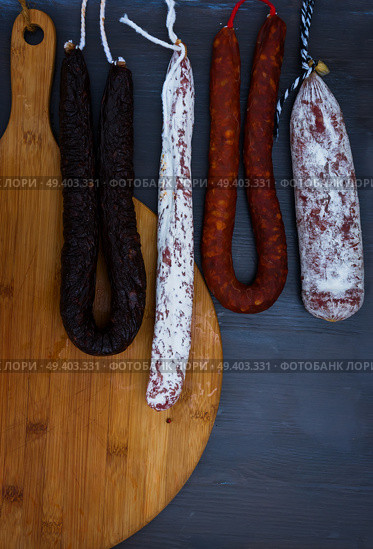 Cured meat and sausages hanging a rack at market.. Cured meat and sausages. Стоковое фото, агентство Ingram Publishing / Фотобанк Лори