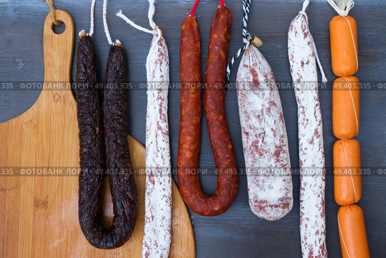 Cured meat and sausages hanging at market. Cured meat and sausages. Стоковое фото, агентство Ingram Publishing / Фотобанк Лори