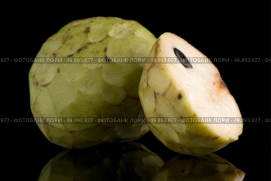 Custard apple, also known as Bullocks or Bulls Heart.On black with reflection. Стоковое фото, агентство Ingram Publishing / Фотобанк Лори