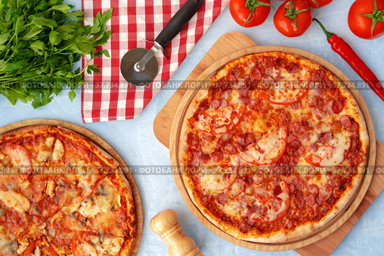 Delicious pizza with sausages on gray background. Стоковое фото, фотограф Сергей Толмачёв / Фотобанк Лори