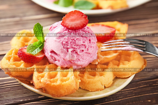 Delicious waffles with ice cream and strawberry on plate. Стоковое фото, фотограф Pixel_shot / Фотобанк Лори