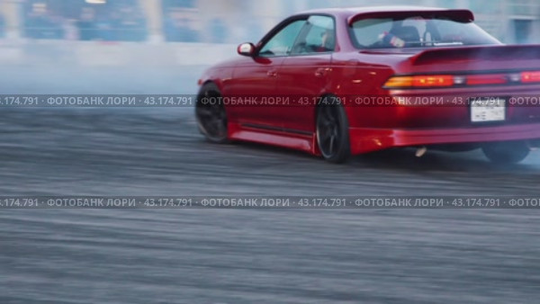 Demonstration performance of an athlete on a red drift car at the Mega Belaya Dacha site. The d live drift festival from under the wheels. Russia. Moscow. 19.05.2024. Редакционное видео, видеограф Ярославский Максим / Фотобанк Лори