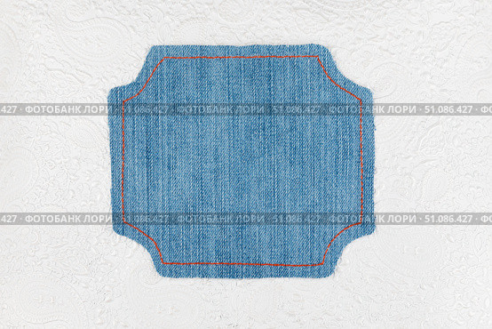Denim frame lies on a white with pattern skin. Стоковое фото, фотограф Александр Собко / Фотобанк Лори