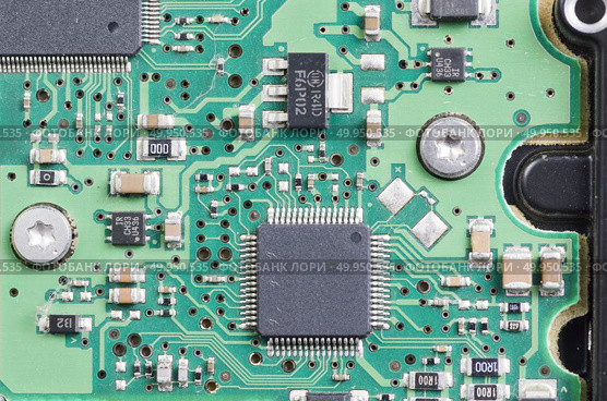 Detail of an electronic printed circuit board with many electrical components. Стоковое фото, агентство Ingram Publishing / Фотобанк Лори