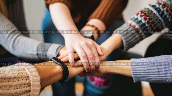 Diverse group of individuals gathering in a circle, unified as they put their hands together in a gesture of teamwork and unity. Стоковое AI-изображение, AI-художник Данила Большаков / Фотобанк Лори