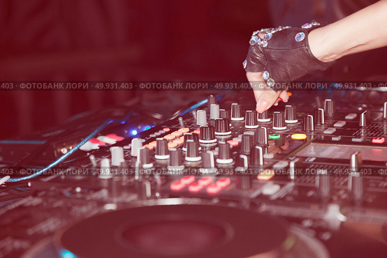 DJ mixes tracks at a party. DJ control panel. Стоковое фото, агентство Ingram Publishing / Фотобанк Лори