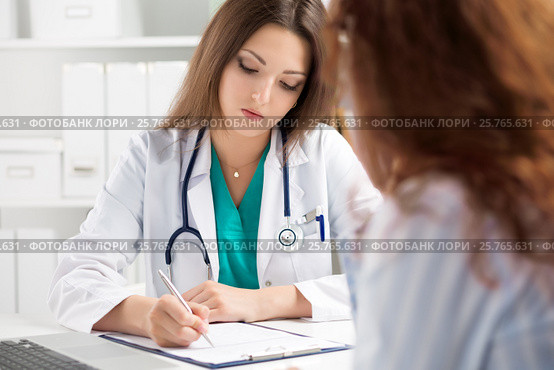 Doctor filling medical form while patient consultation. Стоковое фото, фотограф Людмила Дутко / Фотобанк Лори