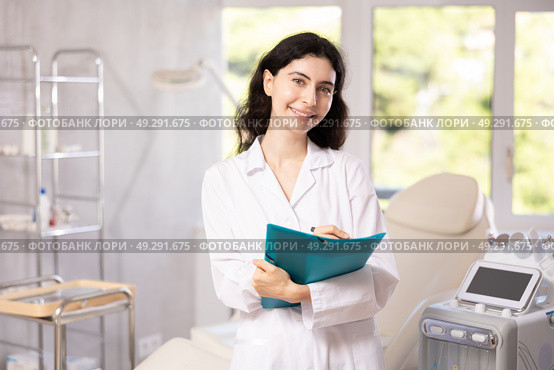 doctor meticulously stands in her clinic. Стоковое фото, фотограф Яков Филимонов / Фотобанк Лори