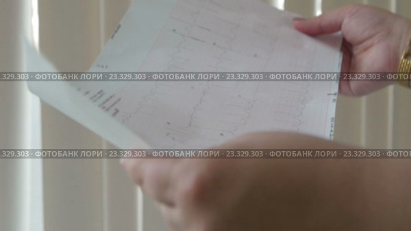 Доктор анализирует результаты электрокардиограммы. Стоковое видео, видеограф Константин Шишкин / Фотобанк Лори