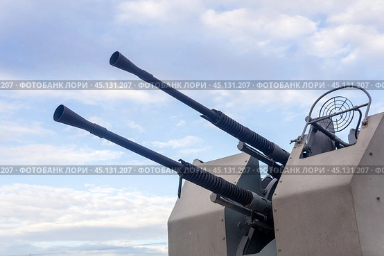 Double-barreled naval automatic cannon against the sky close-up, military background. Стоковое фото, фотограф Евгений Харитонов / Фотобанк Лори