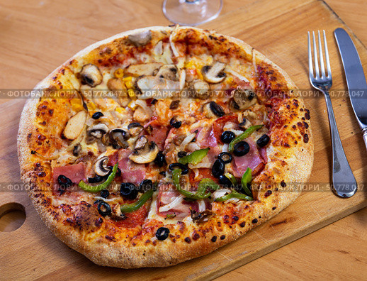 Double pizza served on wooden board. Стоковое фото, фотограф Яков Филимонов / Фотобанк Лори