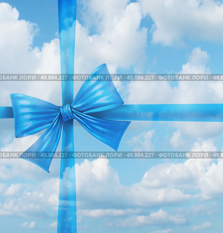 Dream gift from a fantasy wish list concept as an imaginary silk ribbon and bow on a sky background as a symbol of dreaming of holiday hopes for a merry Christmas and a joyful newyear. Стоковое фото, агентство Ingram Publishing / Фотобанк Лори