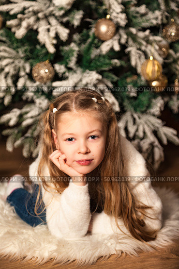 Dreaming of Christmas Morning in Front of the Decorated Christmas Tree. Стоковое фото, фотограф Aleksandr Golubev / Фотобанк Лори