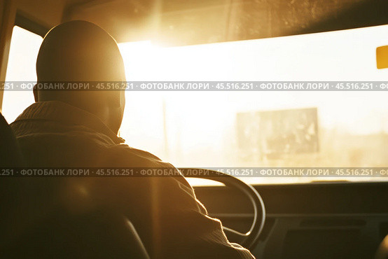 Driver turns steering wheel of truck, bus at sunset time. Skilled chauffeur drives lorry to deliver freight. Cargo shipping service. Drives Journey. Drivers silhouette against a vivid sundown. Travel. Стоковое AI-изображение, AI-художник Марина Демидюк / Фотобанк Лори