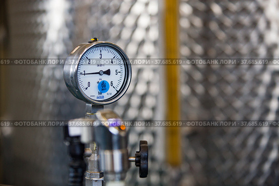 Ekibastuz, Kazakhstan - May 28, 2012. Explosive material production plant for coal quarry mining. Manometer gauge close up. Stainless steel tank on background. Стоковое фото, фотограф Alexey Rezvykh / Фотобанк Лори