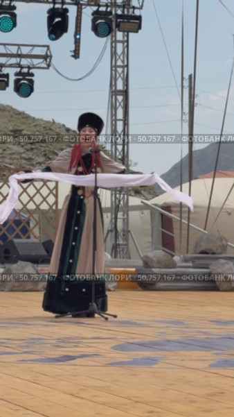 ELANTSY, IRKUTSK REGION, RUSSIA - July 5, 2025: Erdynskie Games– festival of nomadic peoples of Eurasia. Beautiful Buryat girl in national costume on open stage in Beauty Contest. Vertical video. Редакционное видео, видеограф Виктория Катьянова / Фотобанк Лори