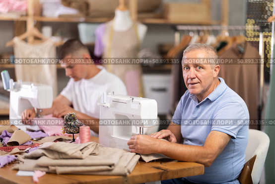 Elderly and young man sew on machine in workshop. Стоковое фото, фотограф Яков Филимонов / Фотобанк Лори