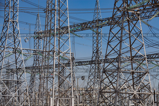 Electrical distributing substation. Pylons and cables. Blue sky background. Стоковое фото, фотограф Alexey Rezvykh / Фотобанк Лори