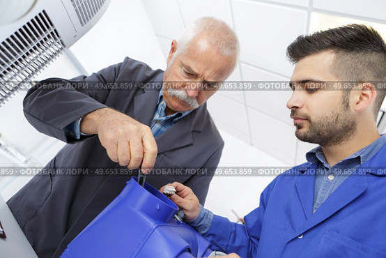 electrician with apprentice working in new home. Стоковое фото, агентство Ingram Publishing / Фотобанк Лори